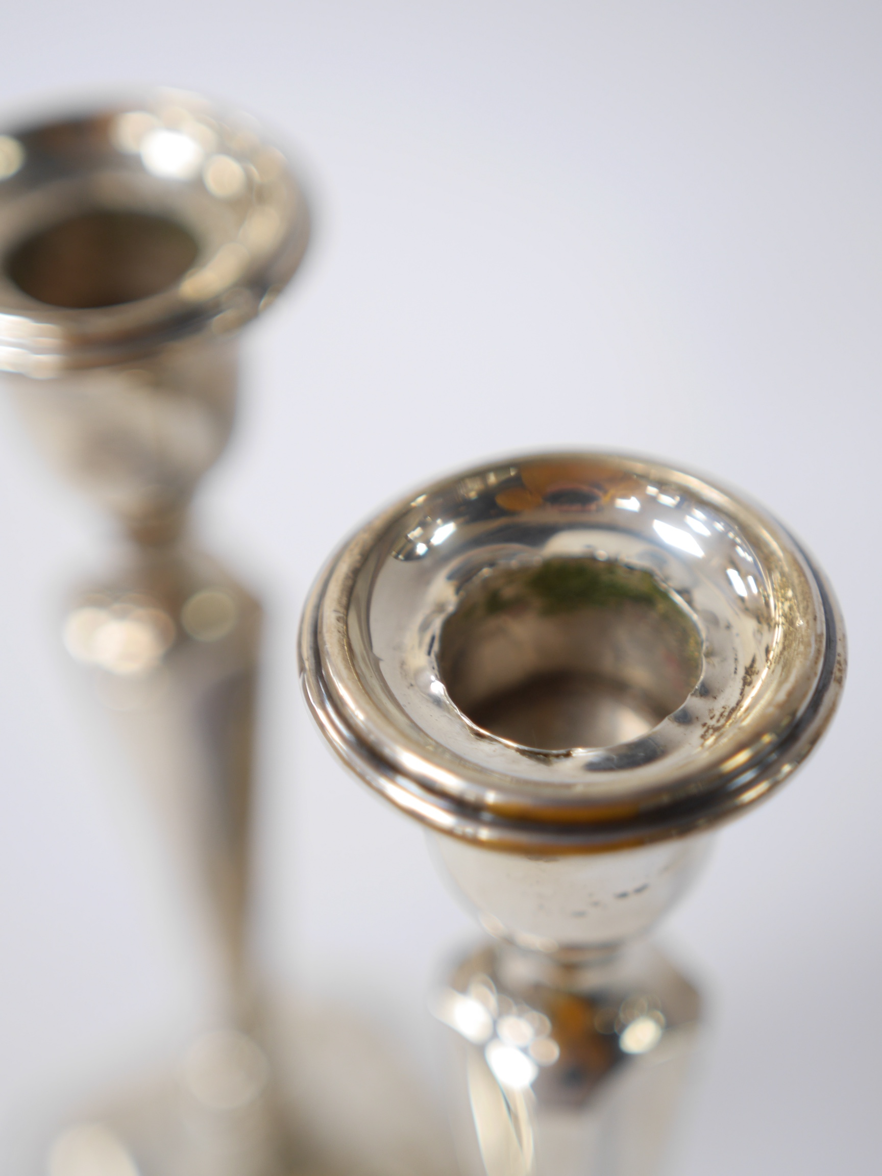 A pair of George V silver candlesticks, Birmingham, 1921, 19.9cm, weighted. Condition - poor